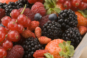 Mixed berries in a wooden basket.