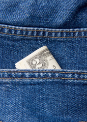 two dollar in pocket of blue jeans