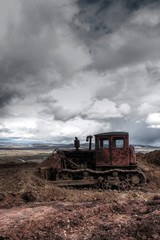 Agricultural tractor (machinery) cultivating soil .