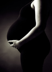 Pregnant Woman Supporting her Belly
