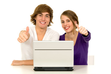 Couple using laptop showing thumbs up