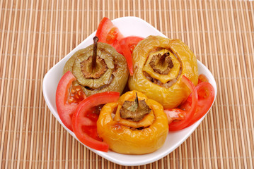 Stuffed paprika and tomato on a plate