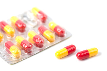 red and yellow capsule pills in blister isolated