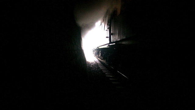 Steam train entering tunnel