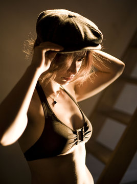 young and sexy beautiful woman with a hat wearing bra