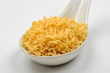 organic home made neylon sev on a spoon