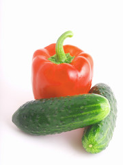 Red Bulgarian pepper and two cucumbers on a white background