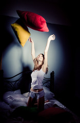 Girl throws up pillows