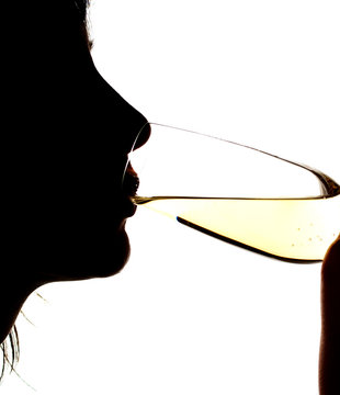 Silhouette of the girl drinking sparkling wine