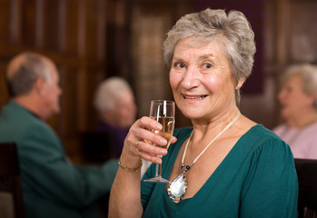 Happy senior lady in restaurant