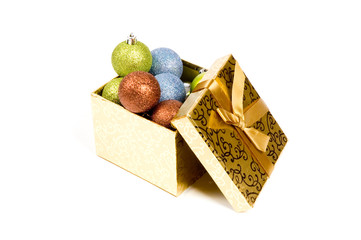 open gift box filled with christmasballs isolated on a white bac