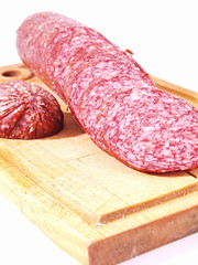 The cut sausage on a white background