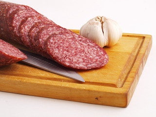 The cut sausage on a white background