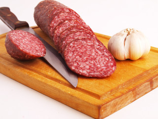 The cut sausage on a white background