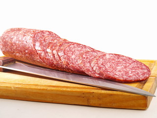 The cut sausage on a white background