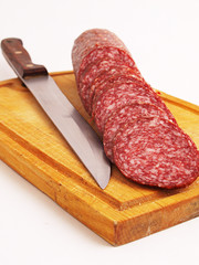 The cut sausage on a white background