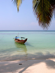 Boat on a calm sea shore, Koh Phangan, Thailand.