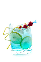 Blue alcohol cocktail with lemon slices and maraschino