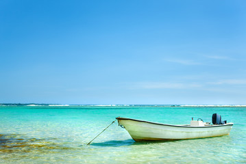 Sailboat anchored in Caribbean sea on a summer day