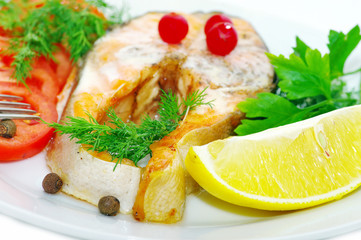 grilled fish with vegetables and slice of lemon