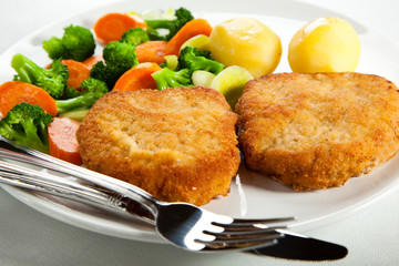 Fried pork chop  with boiled potatoes and vegetables
