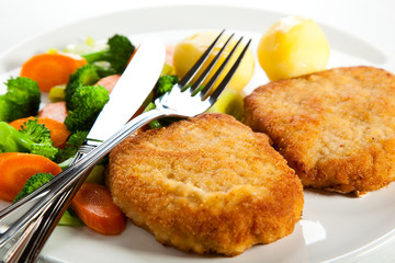 Fried pork chop  with boiled potatoes and vegetables