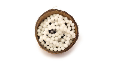 beautiful white pearl necklace lies in the half coconut