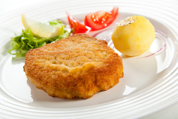 Fried pork chop  with boiled potatoes and vegetables
