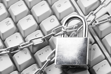 Computer  keyboard secured with chain and padlock..