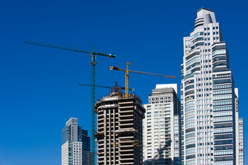 Fototapeta premium Concrete Building Construction with Cranes