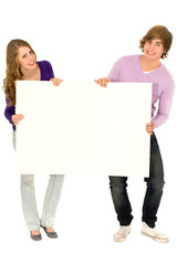 Young couple holding a billboard