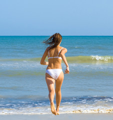 Fototapeta na wymiar Active girl on a beach