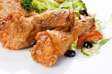 Roasted chicken legs with salad.