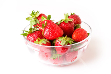 A glass bowl full of fresh strawberries.