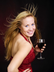 smiling beautiful woman holding wine and celebrating new year