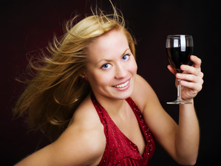 smiling beautiful woman holding wine and celebrating