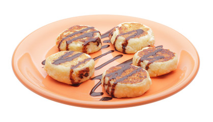 cheese pancakes with chocolate syrup on orange plate