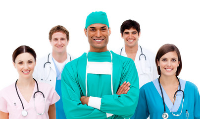 Confident surgeon with his team in the background