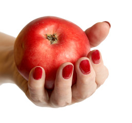 Hand of the elderly lady holding an apple