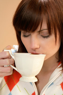 Woman drinking tea with closed eyes
