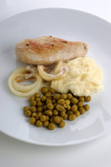 mash potato with organic pea and meat on a plate