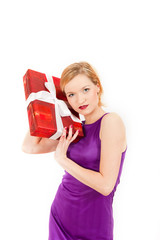 Young happy winter woman with red christmas present