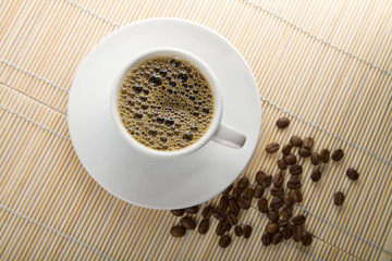 cup of coffee and roasted beans