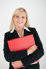 Young business woman in a black suit with folder