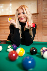 Young sexy woman with billiard balls