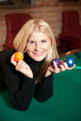 Young sexy woman with billiard balls