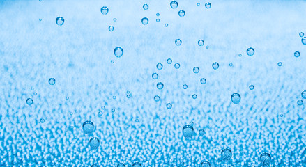 Naklejka na ściany i meble Macro of blue air bubbles in water