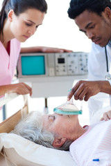 Fototapeta premium Medical team resuscitating a senior patient