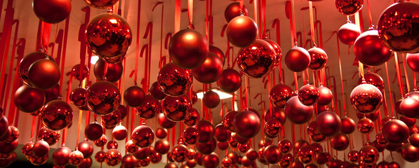 Red Ornaments hanging from Red Ribbons