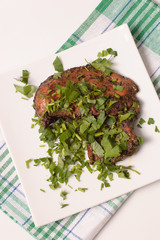 chicken with herbs on a white plate